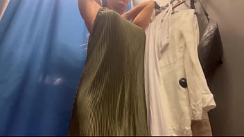 A woman with big boobs in a public fitting room