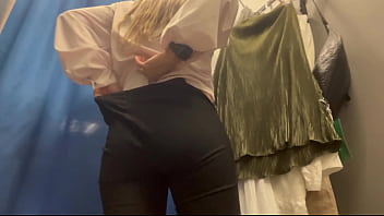 A woman with big boobs in a public fitting room