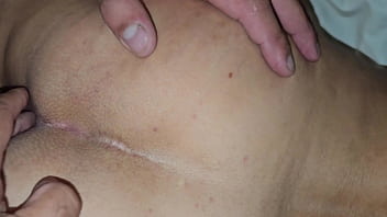 The cuckold is helping to insert his penis into his wife's small anus and the lover says he's only going to put the head of his penis in