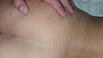 The cuckold is helping to insert his penis into his wife's small anus and the lover says he's only going to put the head of his penis in