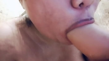 Sucking on a big realistic and messy full of milk dildo closeup