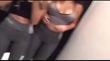 Two hot chicks licking each other in dress room