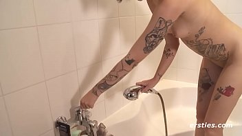 Tattooed babe showers with butt plug in her hole