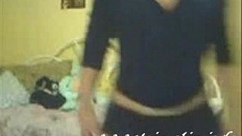 Hot and sexy blonde girl dances and strips in her bedroom