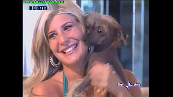 Live television panty oops upskirt as a hottie picks up a dog and leaves her underwear on display