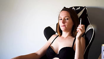 Busty brunette smoking in black bra