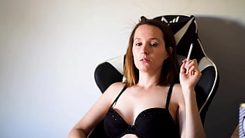 Busty brunette smoking in black bra