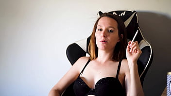 Busty brunette smoking in black bra