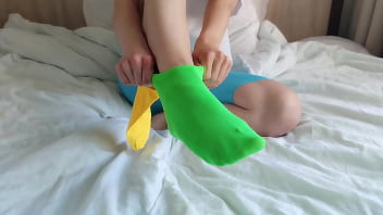 Her brightly colored mismatched socks are perfect for a sensual sockjob