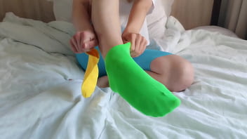 Her brightly colored mismatched socks are perfect for a sensual sockjob
