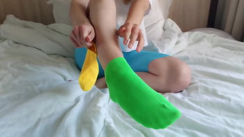 Her brightly colored mismatched socks are perfect for a sensual sockjob