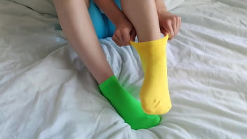 Her brightly colored mismatched socks are perfect for a sensual sockjob