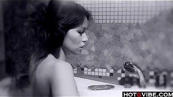 Petite asian plays with her toys in the bathtub