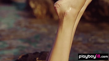 Skinny small titted babe posing naked in the rocks