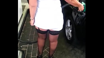 Milf in stockings fills tank in public