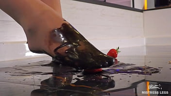 Goddess messy her nylon feet in chocolate close up and squeezing strawberries