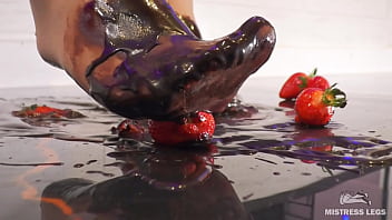 Goddess messy her nylon feet in chocolate close up and squeezing strawberries