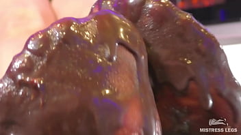 Goddess messy her nylon feet in chocolate close up and squeezing strawberries